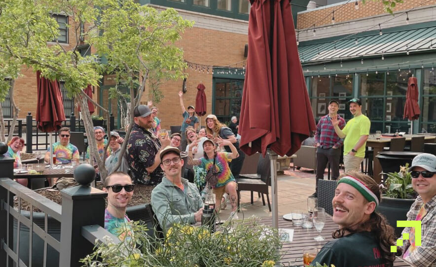 The Creed team enjoying happy hour on the patio after Camp Creed.