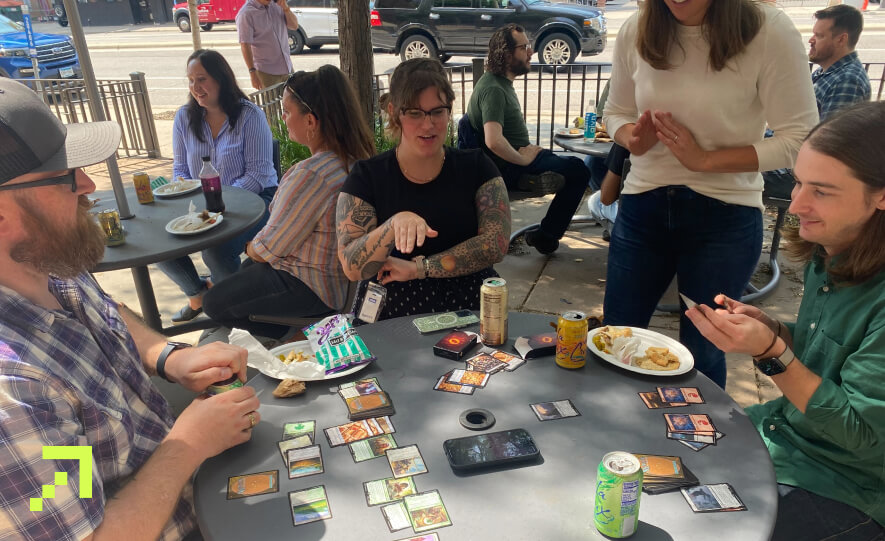 Creed members playing a game of Magic the Gathering during team lunch